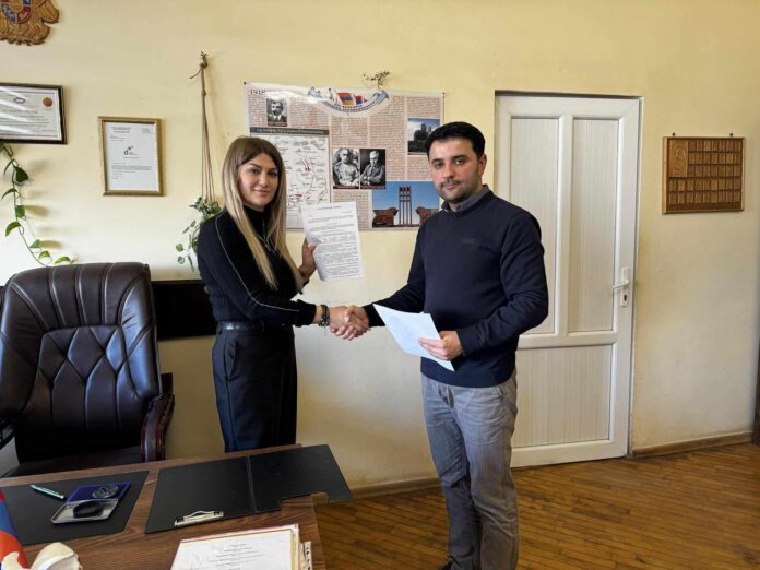 Hasmik Mkrtchyan plays in front of a Komitas portrait.