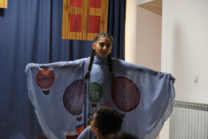 Words on a cloak: happiness, friendship, kindness, love